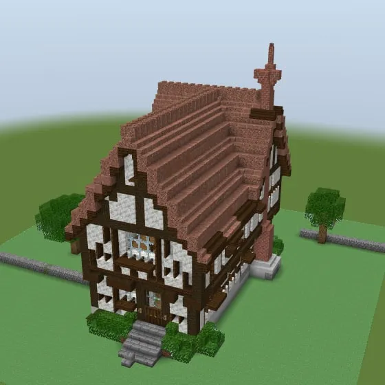Minecraft build of the Tudor house with a steep brown roof, dark timber framing on white walls and a chimney