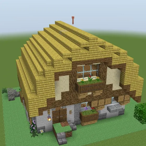 Minecraft build of the cottage with a straw thatched roof, a timber gable and a stone ground floor